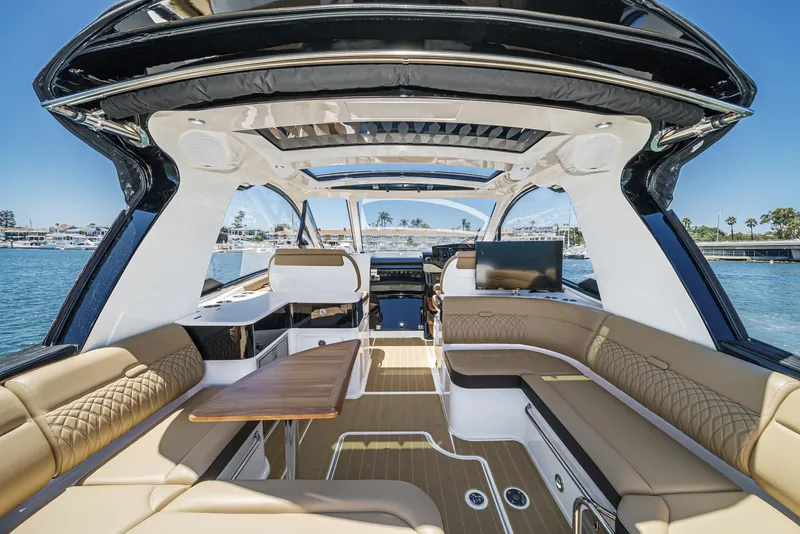 Slide: The Image of 2023 Sea Ray Sundancer 370 OB interior with luxurious seating and open deck view. - 15