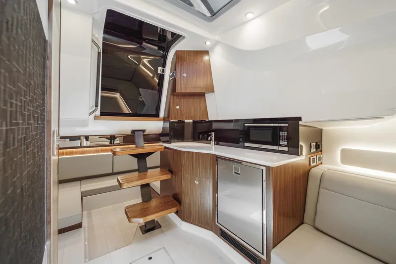 Slide: The Image of 2023 Sea Ray Sundancer 370 OB interior with modern kitchen and seating area. - 32