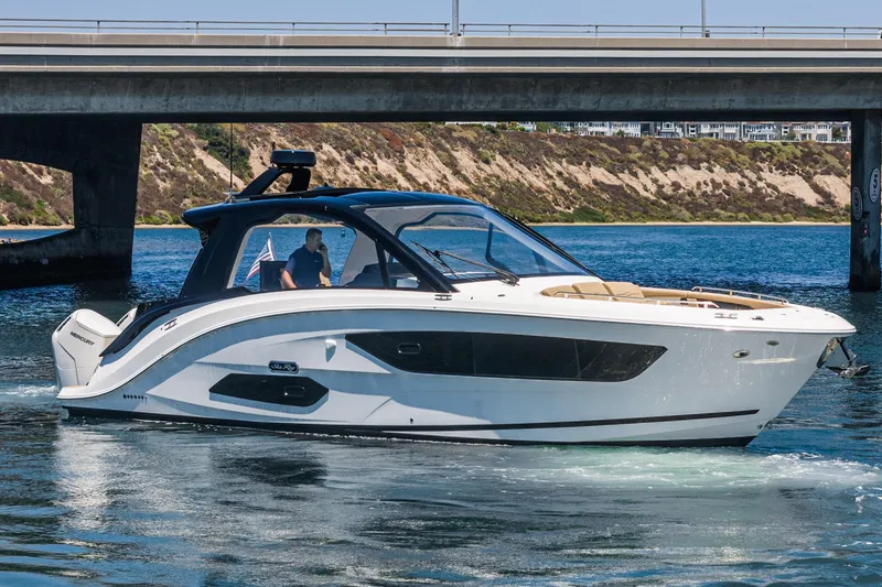Slide: The Image of 2023 Sea Ray Sundancer 370 OB cruising under a bridge on a sunny day. - 8