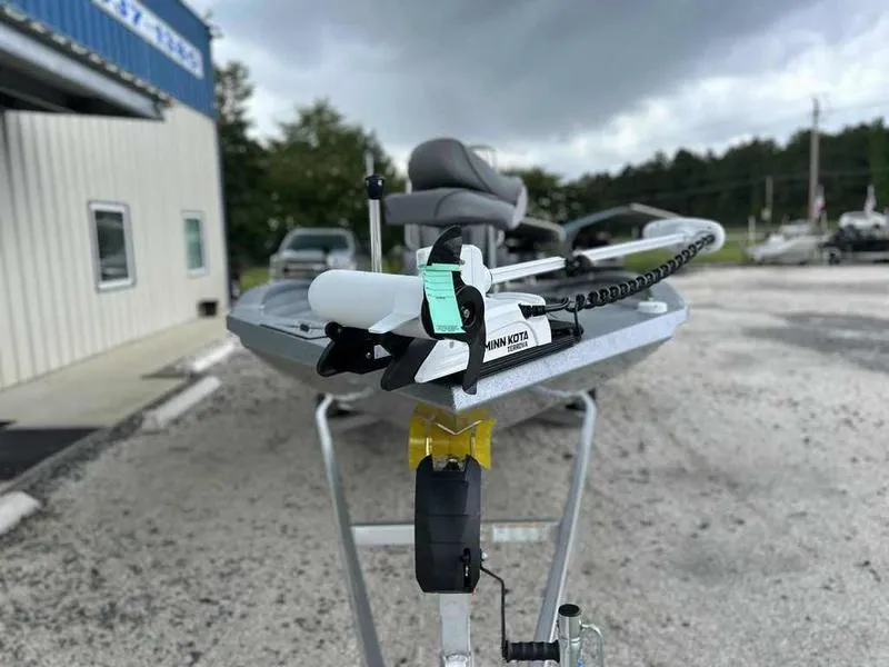 Slide: The Image of 2025 Xpress H22 Bay boat on trailer, featuring Minn Kota trolling motor. - 12