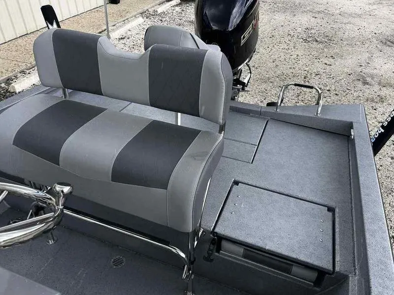 Slide: The Image of 2025 Xpress H22 Bay boat interior with gray seating and storage compartments. - 13