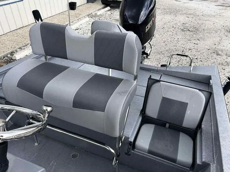 Slide: The Image of 2025 Xpress H22 Bay boat interior with gray seating and steering wheel. - 14