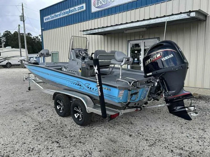 Slide: The Image of 2025 Xpress H22 Bay boat with Yamaha engine, parked outside a dealership. - 3