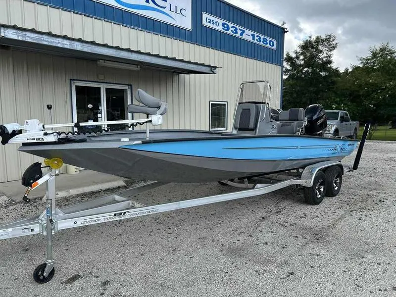 Slide: The Image of 2025 Xpress H22 Bay boat on trailer outside dealership. - 4