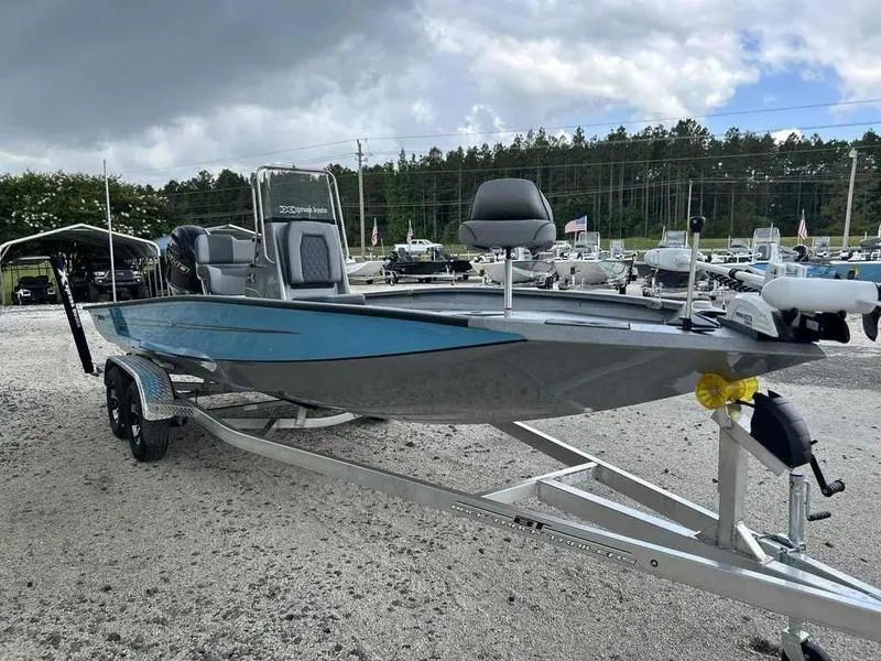 Slide: The Image of 2025 Xpress H22 Bay boat on trailer, displayed outdoors under cloudy sky. - 5