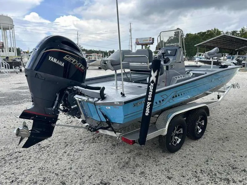 Slide: The Image of 2025 Xpress H22 Bay boat with Yamaha engine on a trailer. - 6