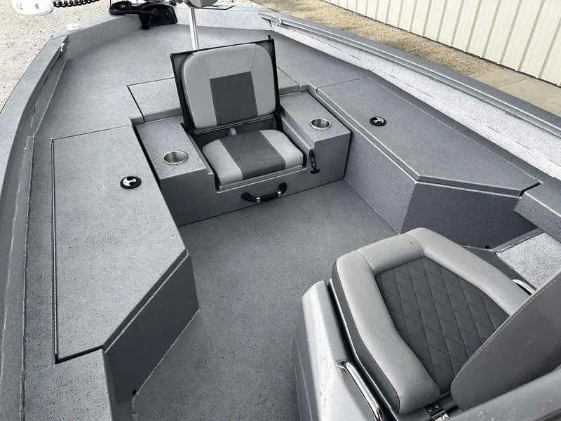 Slide: The Image of 2025 Xpress H22 Bay boat interior with gray seating and storage compartments. - 9