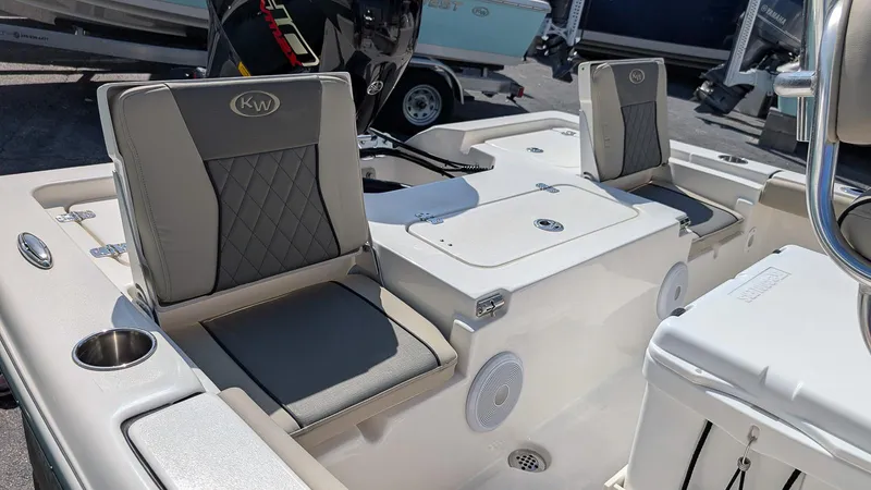 Slide: The Image of 2025 Key West 210 Bay Reef boat interior with cushioned seating and storage compartments. - 10