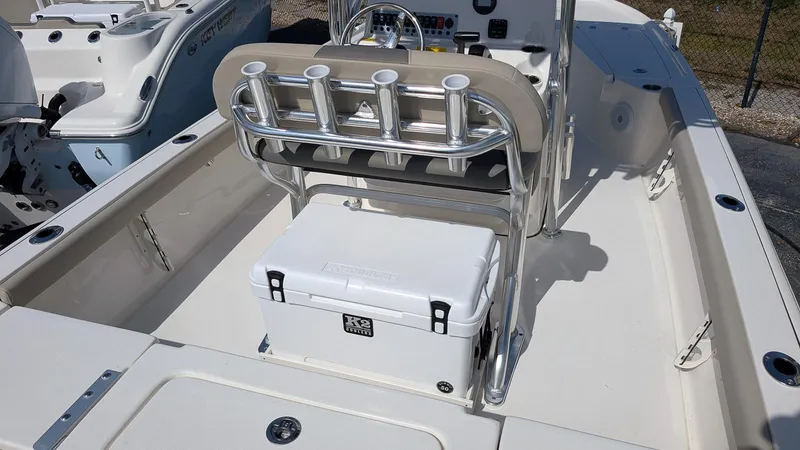 Slide: The Image of 2025 Key West 210 Bay Reef boat interior with rod holders and cooler. - 11