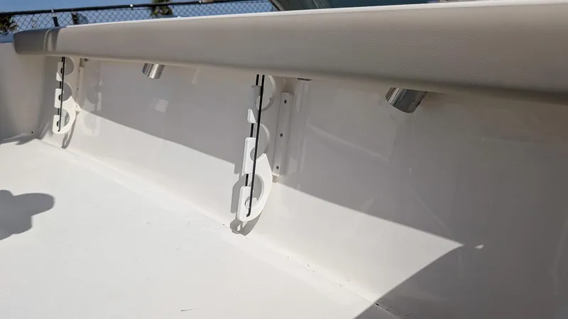 Slide: The Image of 2025 Key West 210 Bay Reef boat interior detail with rod holders. - 13