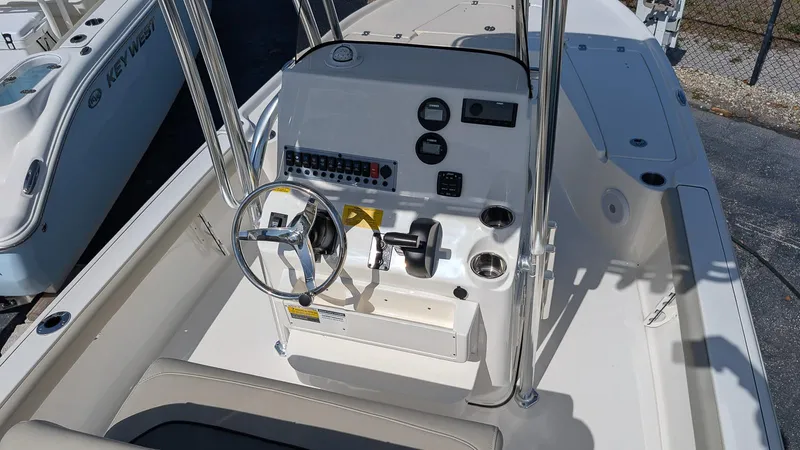 Slide: The Image of 2025 Key West 210 Bay Reef boat console with steering wheel and controls. - 14