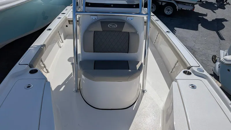 Slide: The Image of 2025 Key West 210 Bay Reef boat interior with seating and storage compartments. - 17
