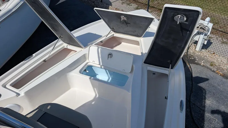 Slide: The Image of 2025 Key West 210 Bay Reef boat with open storage compartments and clean deck design. - 19