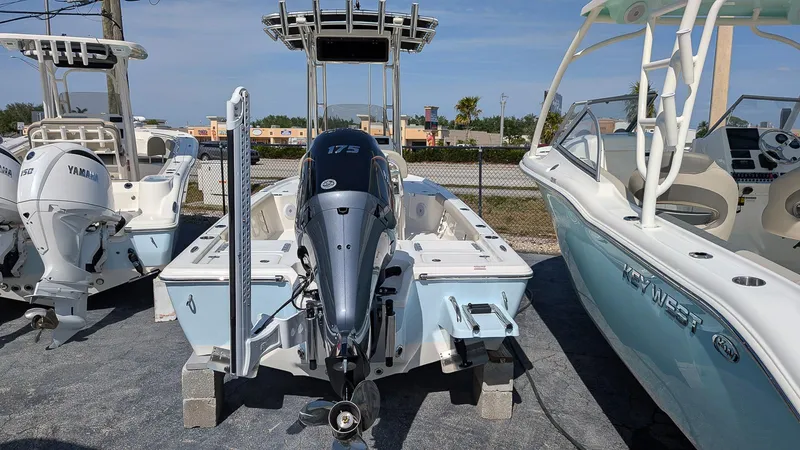 Slide: The Image of 2025 Key West 210 Bay Reef boat with Yamaha engine displayed outdoors. - 2