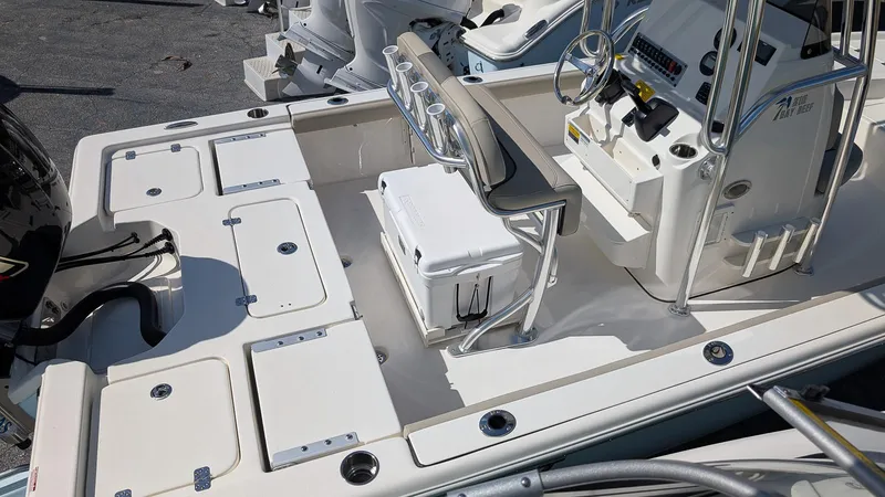 Slide: The Image of 2025 Key West 210 Bay Reef boat interior with seating and storage compartments. - 7
