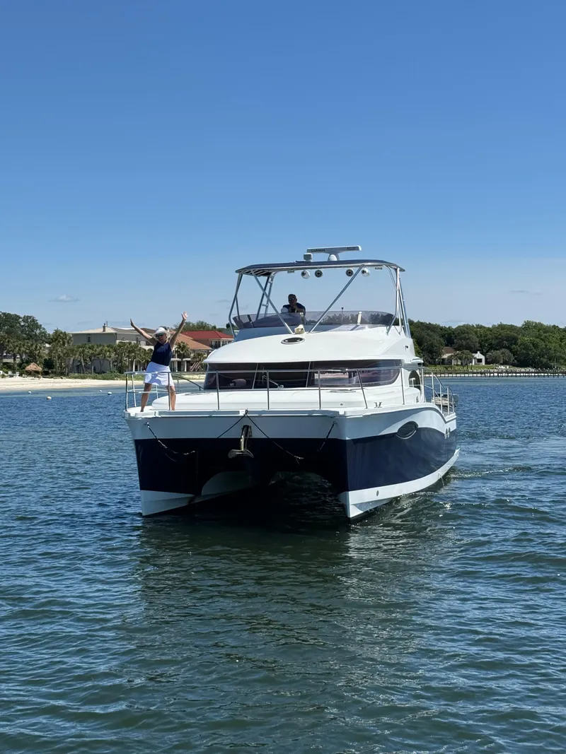 Slide: The Image of Fountaine Pajot 40 catamaran cruising on water, 2012 model, with people enjoying the ride. - 1