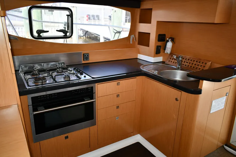 Slide: The Image of Modern kitchen in a 2012 Fountaine Pajot 40 catamaran with stove, oven, and sink. - 12