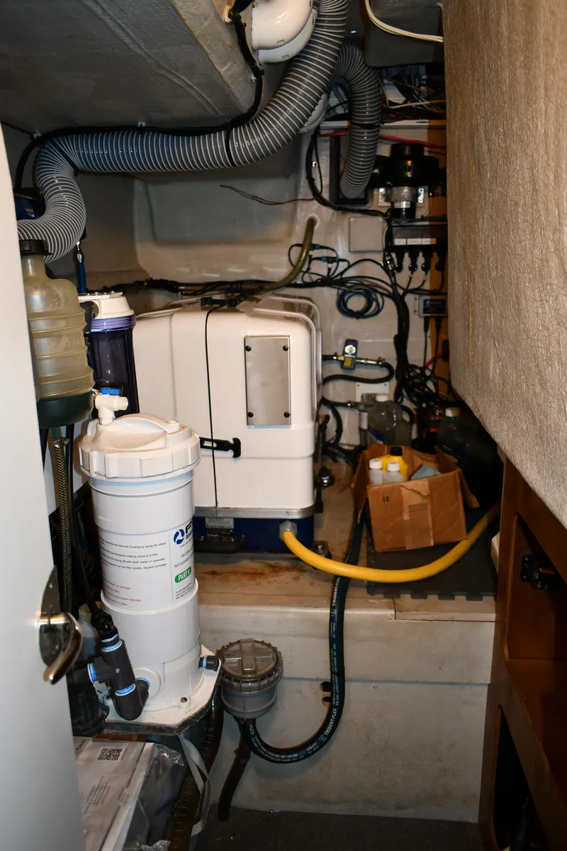 Slide: The Image of Engine room of 2012 Fountaine Pajot 40 catamaran with mechanical equipment and hoses. - 16