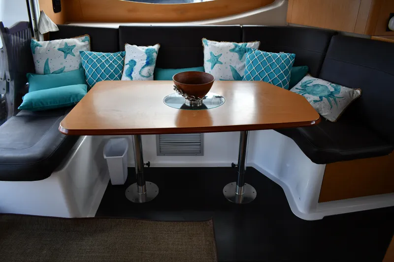 Slide: The Image of Cozy dining area in 2012 Fountaine Pajot 40 catamaran with decorative pillows and wooden table. - 21