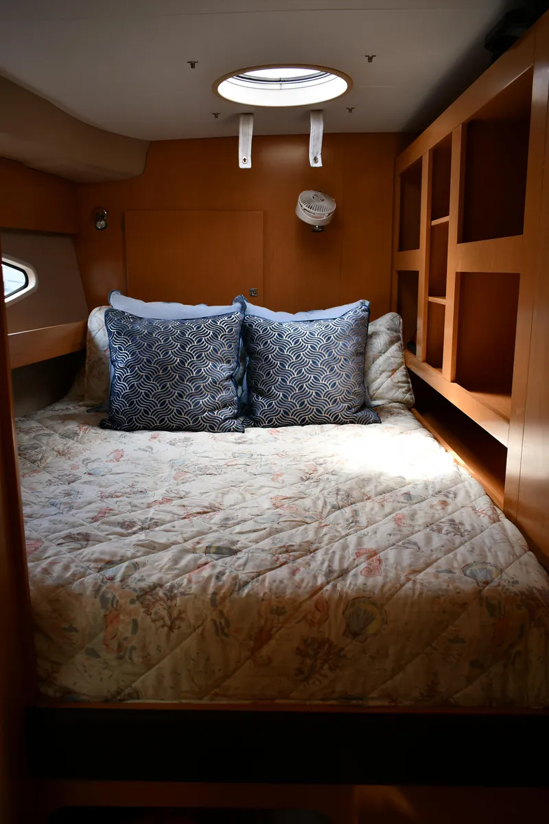 Slide: The Image of Cozy cabin interior of 2012 Fountaine Pajot 40 catamaran with bed and decorative pillows. - 40
