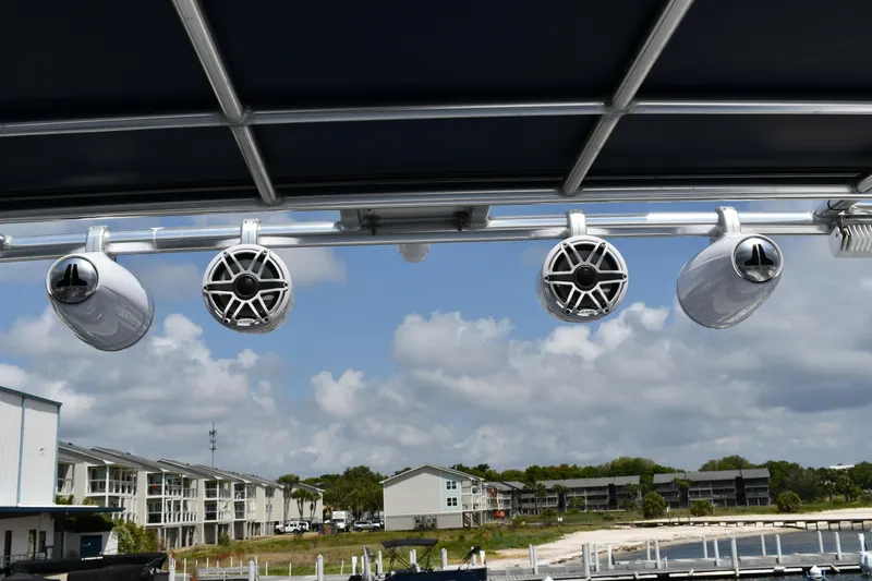 Slide: The Image of Rooftop speakers on a 2012 Fountaine Pajot 40 catamaran, with a scenic marina backdrop. - 45