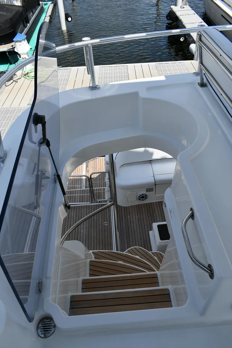 Slide: The Image of Staircase on 2012 Fountaine Pajot 40 yacht, leading to deck with wooden flooring. - 49
