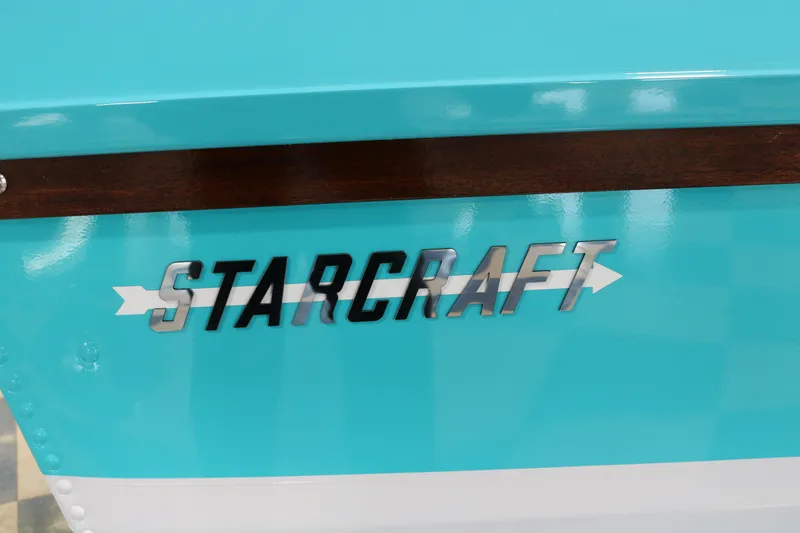 Slide: The Image of Starcraft 57 Ski Champ 2025 logo on turquoise and white boat exterior. - 12