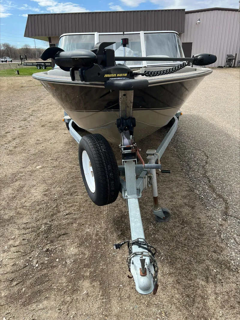 Slide: The Image of 1998 Tracker Targa 185 WT boat on trailer, parked outdoors. - 14