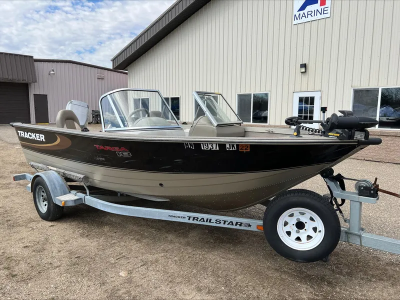 Slide: The Image of 1998 Tracker Targa 185 WT boat on a trailer, parked outside a building. - 3