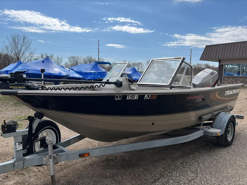 Slide: The Image of 1998 Tracker Targa 185 WT boat on trailer, parked outdoors under blue sky. - 4