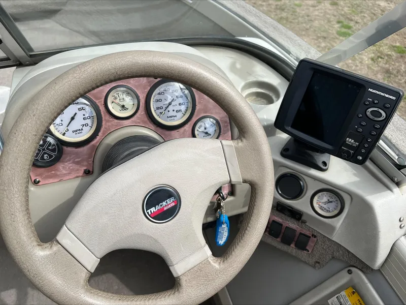 Slide: The Image of Steering wheel and dashboard of 1998 Tracker Targa 185 WT boat with gauges and fishfinder. - 9