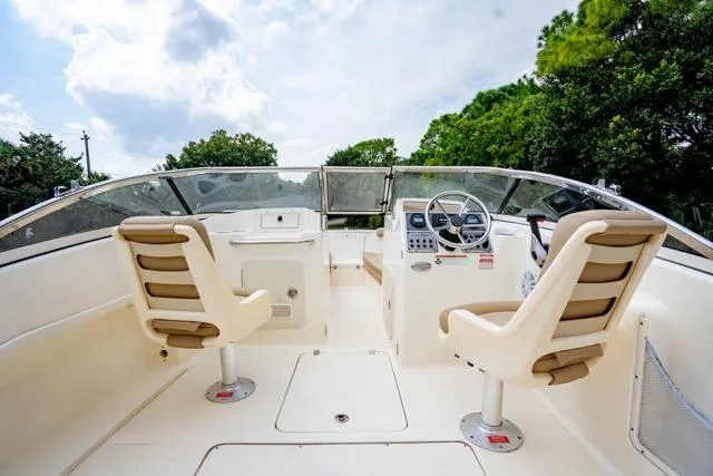 Slide: The Image of 2021 Scout 210 Dorado boat interior with dual seats and steering console. - 11