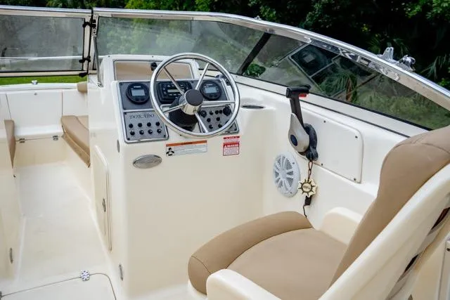 Slide: The Image of 2021 Scout 210 Dorado boat interior with steering wheel and control panel. - 13
