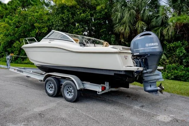 Slide: The Image of 2021 Scout 210 Dorado boat on trailer with Yamaha outboard motor. - 2