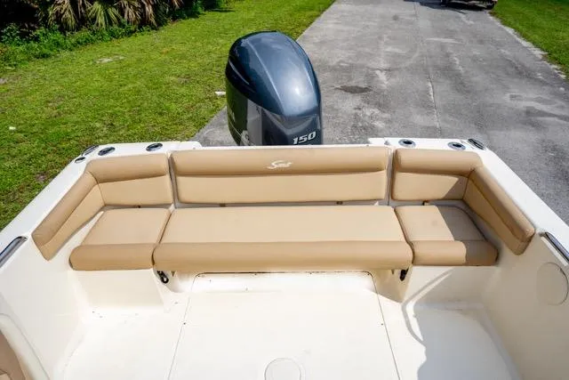 Slide: The Image of 2021 Scout 210 Dorado boat with beige seating and outboard motor. - 9