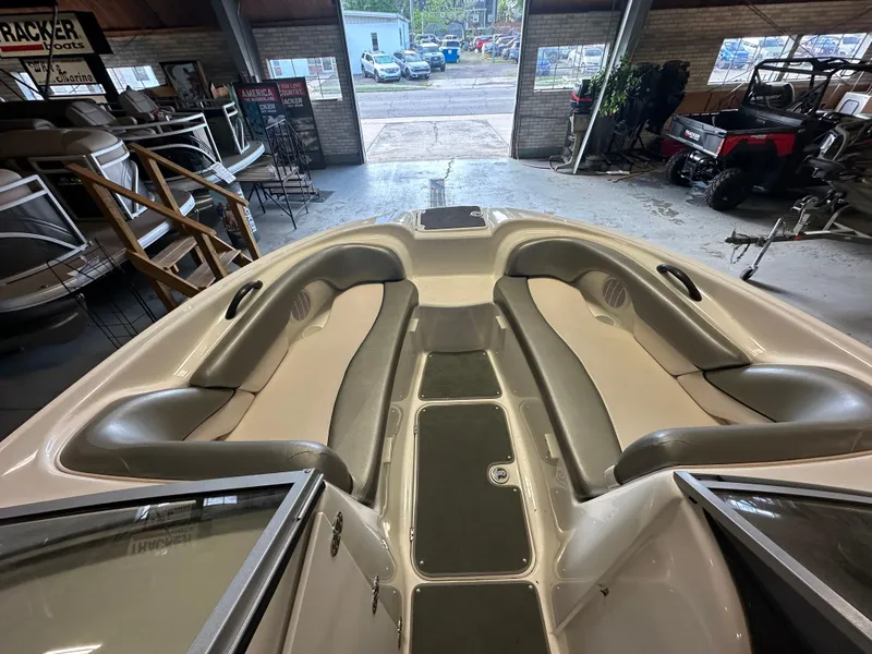 Slide: The Image of 2009 Yamaha SX210 boat interior with spacious seating in a showroom. - 11