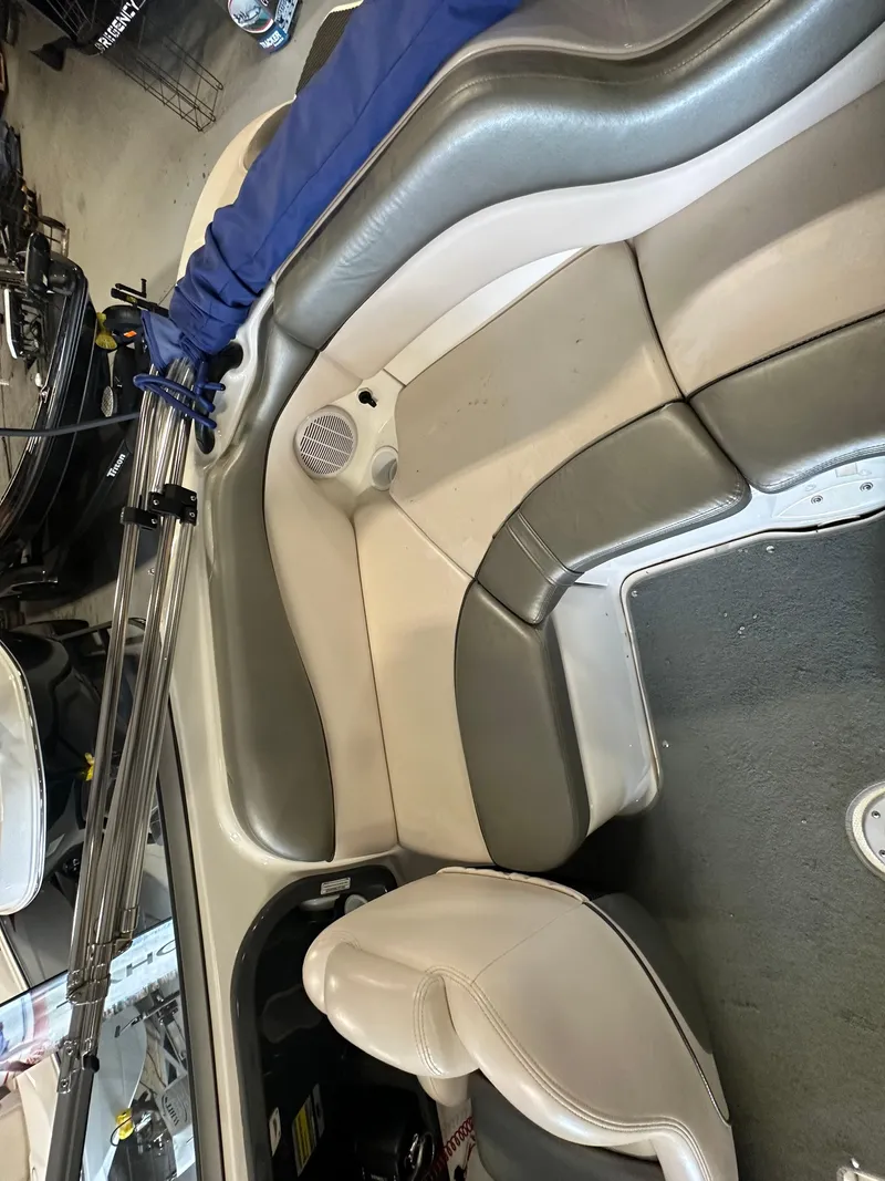Slide: The Image of 2009 Yamaha Boats SX210 interior seating with gray and white upholstery. - 17