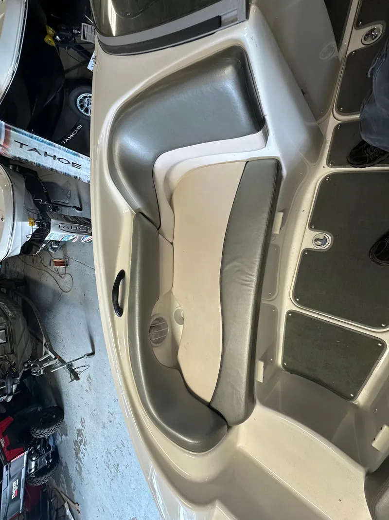 Slide: The Image of 2009 Yamaha SX210 boat interior with gray and beige seating. - 19