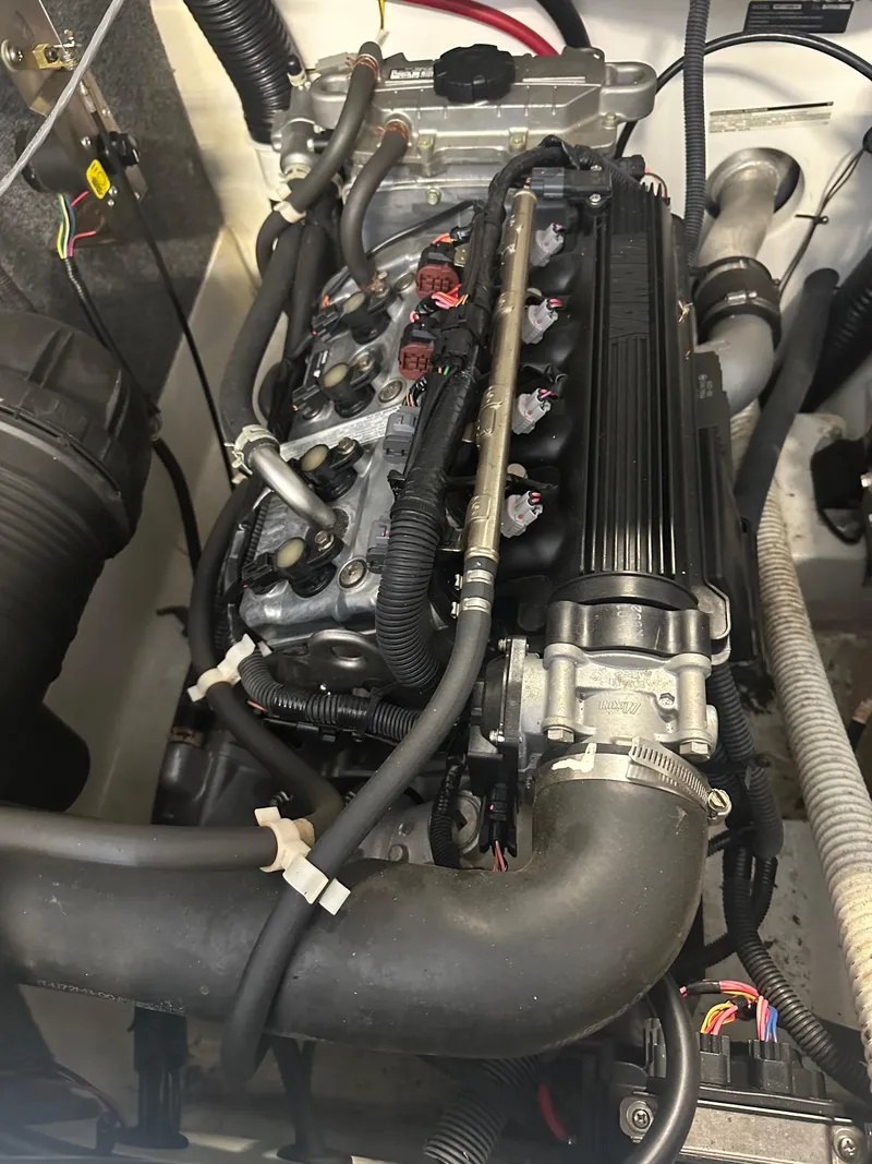 Slide: The Image of 2009 Yamaha Boats SX210 engine compartment with visible components and wiring. - 23