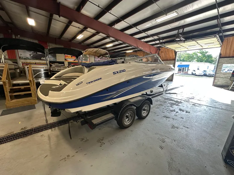 Slide: The Image of 2009 Yamaha SX210 boat on trailer in indoor storage facility. - 7