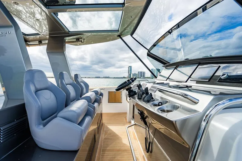 Slide: The Image of 2022 Pardo Yachts 43 interior with modern helm, luxurious seating, and panoramic windows. - 11