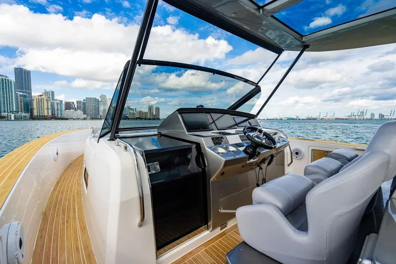 Slide: The Image of 2022 Pardo Yachts 43 helm with city skyline view, featuring modern controls and seating. - 13