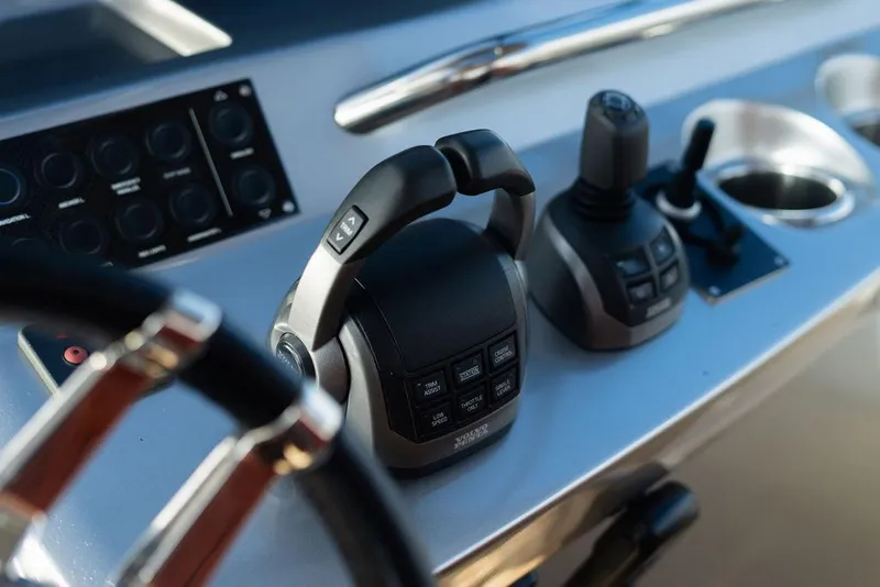 Slide: The Image of Control panel of 2022 Pardo Yachts 43, featuring modern throttle and joystick controls. - 15