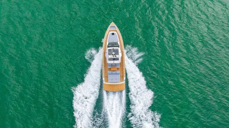 Slide: The Image of 2022 Pardo Yachts 43 cruising on vibrant turquoise water, aerial view. - 22