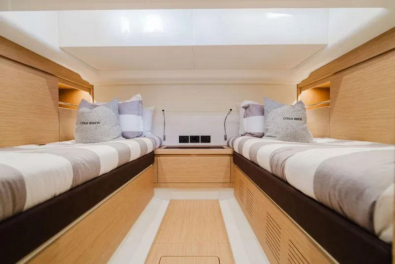 Slide: The Image of Interior of 2022 Pardo Yachts 43, featuring twin beds and modern wood finish. - 5
