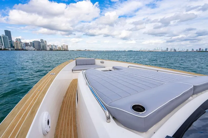 Slide: The Image of Pardo Yachts 43 (2022) on water, featuring spacious deck and city skyline backdrop. - 8