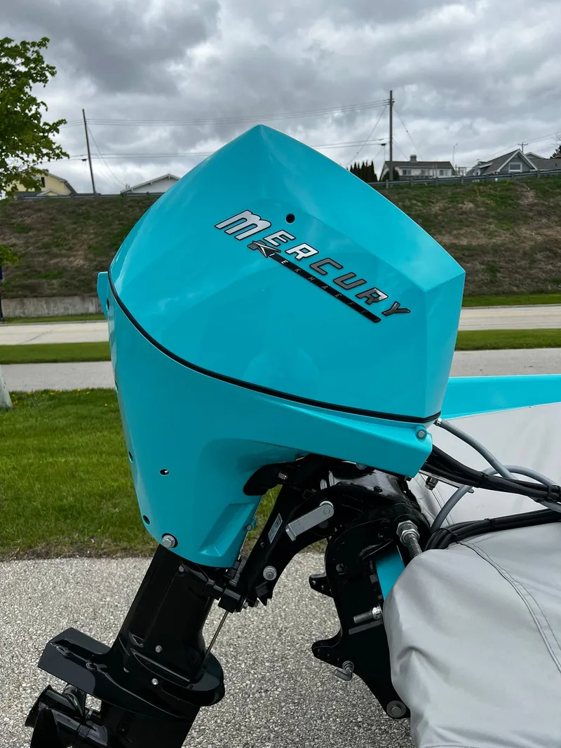 Slide: The Image of Turquoise Mercury outboard motor on 2025 Starcraft 57 SKI CHAMP boat, parked outdoors. - 3