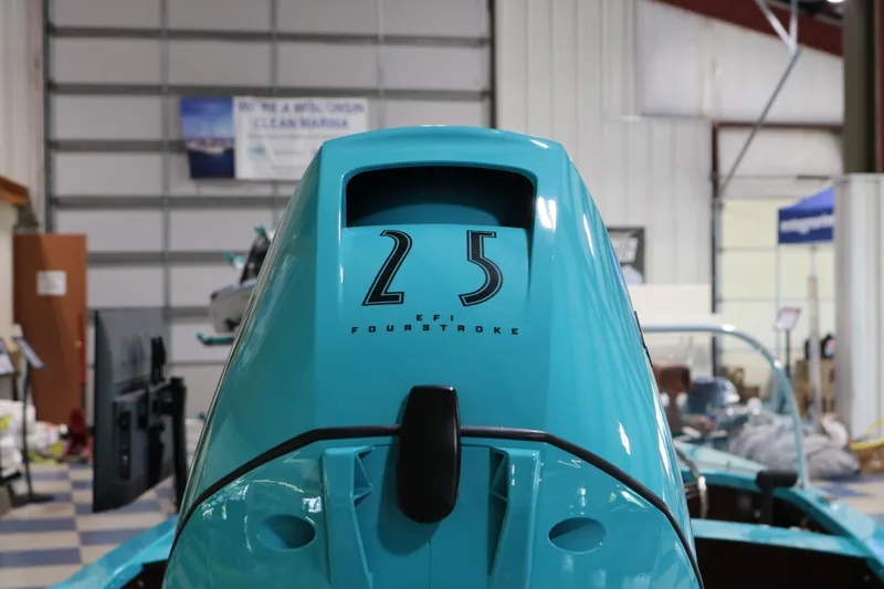 Slide: The Image of 2025 Starcraft 57 Ski Champ outboard motor in a showroom setting. - 11