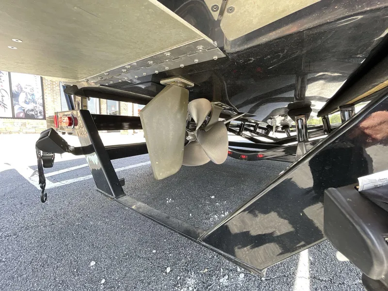 Slide: The Image of 2023 Moomba Craz boat propeller and undercarriage detail in a parking lot. - 13