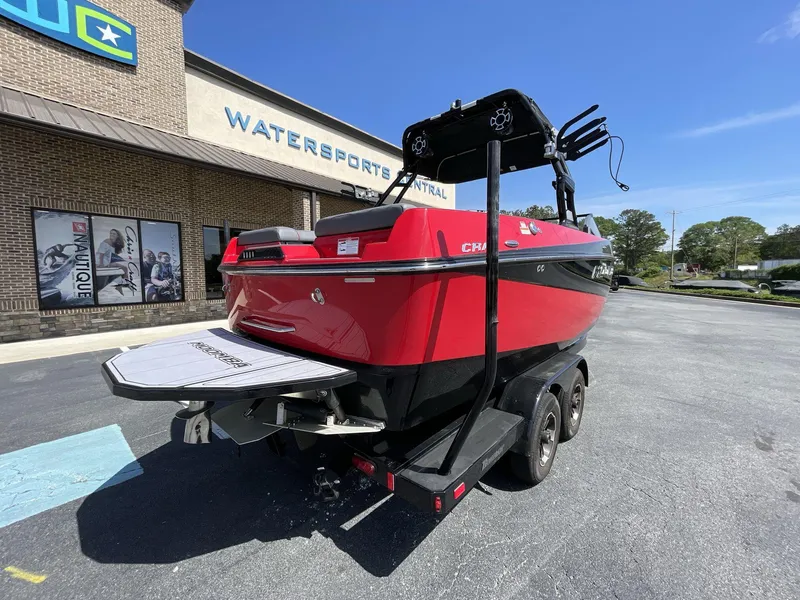 Slide: The Image of 2023 Moomba Craz boat in red, parked outside Watersports Central on a sunny day. - 14
